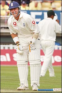 Alec Stewart winces in pain 