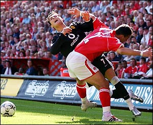 Manchester United's Cristiano Ronaldo is fouled by Charlton's Radostin Kishishev