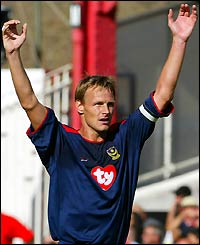 Teddy Sheringham celebrates opening the scoring at Highbury