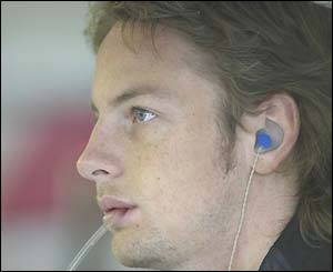 Jensen Button of the BAR team chews his pen as he watches the lap times appear