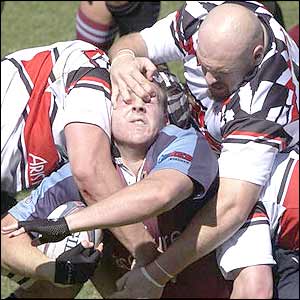 Stephen Moore of University is grabbed around the face by Matt Weaver of the Canberra Vikings during the Brisbane club rugby union semi-final in Brisbane 