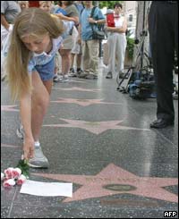 Ten-year-old Rebecca Neumann, from Texas, leaves flowers beside Bob Hopes star on the Hollywood Walk of Fame 