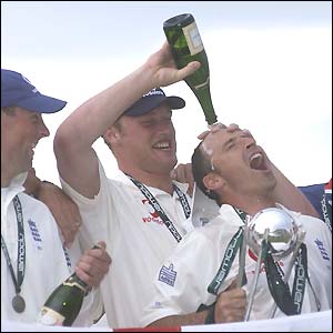 Andrew Flintoff pours champagne on the head of captain Nasser Hussain after a series win over Sri Lanka