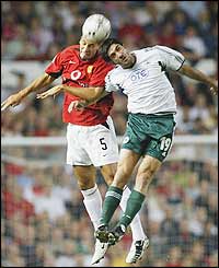 Rio Ferdinand heads the ball away from Michael Konstantinou