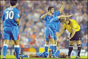 Rangers' Fernando Ricksen is knocked unconscious in the first half at Ibrox 