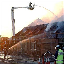 Firefighters damping down