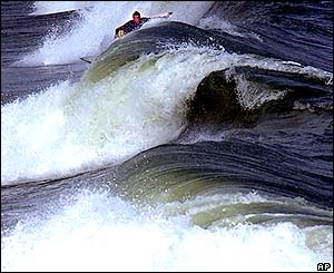 Surfer riding waves of up to eight feet at Surf City, North Carolina
