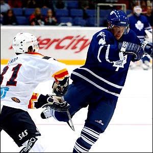 Jarkko Immonen of the Toronto Maple Leafs gets away from Arto Tukio of Helsinki Jokerit during the NHL Challenge