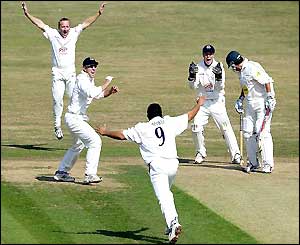 Mushtaq Ahmed and his Sussex team-mates celebrate his 100th wicket of the season