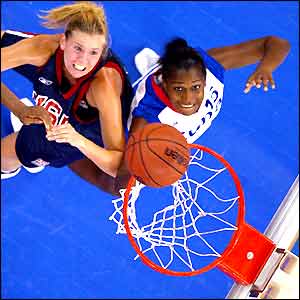 USA's Ann Strother (left) pushes Cuba's Adriana Capiro as she nets a basket
