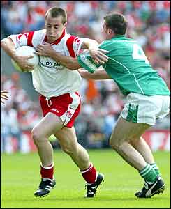 Tyrone's Brian McGuiganand Fermanagh's Michael Lilly 