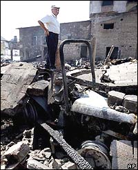 Man surveys damage wreaked by fires