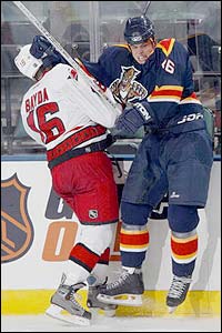 Defender Jeff Paul of the Florida Panthers fights with right wing Jesse Boulerice #36 of the Carolina Hurricanes in the third period