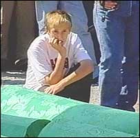 Boy next to coffins