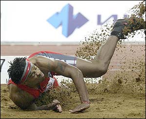 Walter Davis lands in the sand during the men's triple jump competition in the Moscow Challenge event