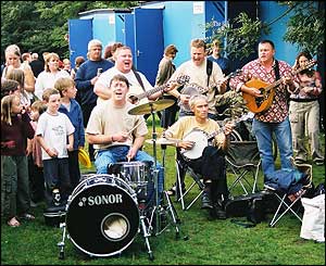 A band plays near the portable loos at the festival