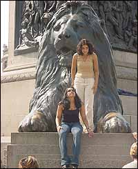 Girls on bronze lion at Trafalgar Square