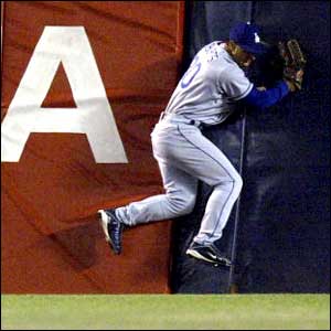 Los Angeles Dodgers centre-fielder Dave Roberts slams into the wall