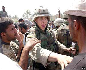 US soldier pushing back crowd