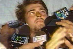 Matthew in hospital bed with microphones