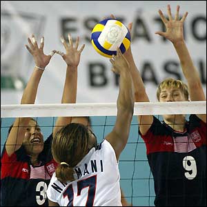 American Ogonna Nnamani (centre) leaps for the ball during the preliminary round of the women's volleyball 