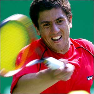 Guillermo Canas of Argentina returns a ball against Eric Taino