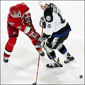 Tampa Bay Lightning's Nikita Alexeev fights for the puck with Radim Vrbata of the Carolina Hurricanes 