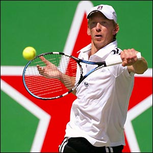 Australia's Wayne Arthurs strikes a return on the way to a 6-4 3-6 7-6 win against Croatia's Ivo Karlovic 