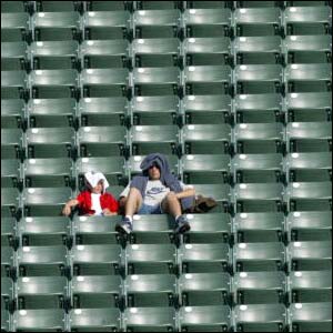 Father and son shelter from the sun as they eagerly await the women's World Cup match between Russia and Ghana