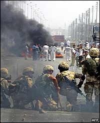 British soldiers face Iraqi rioters as tyres burn 