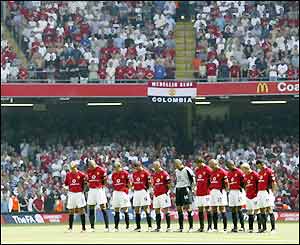 The players honour a minute's silence and wear black armbands at the Millennium Stadium