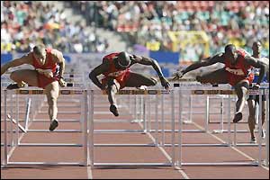 American Allen Johnson (centre) competes in the hurdles