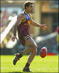 Brisbane Lions' Nigel Lappin gets his kick away during the AFL Grand Final against the Collingwood Magpies 