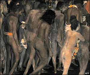 Holy men run towards the water in early hours of morning 