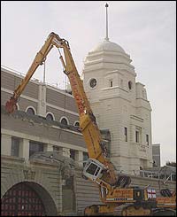 The diggers move in to start the demolition of the stadium