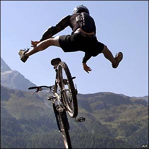 A mountain biker jumps into the Silvaplana lake in the Swiss Alps