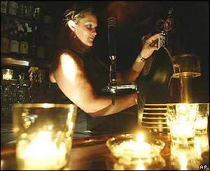 Toronto barmaid serves beers in candlelight