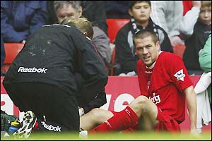 Michael Owen is treated on the sidelines after a nasty fall