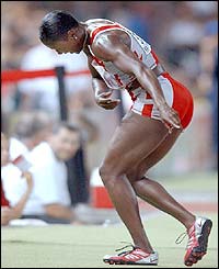 Chryste Gaines celebrates winning the 100m