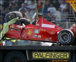 Michael Schumacher's damaged Ferrari is airlifted from the track in 1999