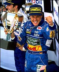 Michael Schumacher celebrates on the podium in 1994 after winning the Belgian Grand Prix