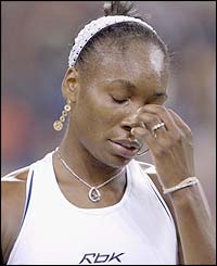 Venus Williams holds her head in her hands