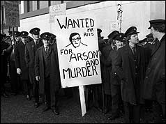 Striking fire fighters carrying banner
