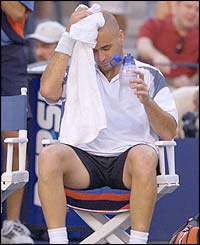 Andre Agassi mops his brow with a towel during a break