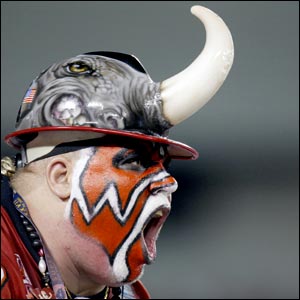 A Tampa Bay Buccaneers wearing a hat with horn and with a painted face supports his team against the Indianapolis Colts