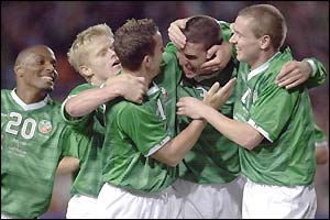 John O'Shea (second from right) is mobbed by his Republic team-mates after scoring their equaliser