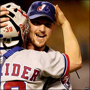 Montreal Expos Rocky Biddle gets a hug from catcher Brian Schneider after picking up the save in the Expos' 7-5 win over the Los Angeles Dodgers