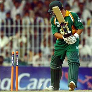 South African batsman Mark Boucher looks back at his wicket after being bowled during the third one-day international in Faisalabad