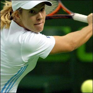 Belgium's Justine Henin-Hardenne returns a shot to Spain's Conchita Martinez during their match at the Porsche Tennis Grand Prix in Filderstadt 