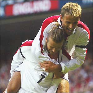 David Beckham celebrates his goal with Phil Neville